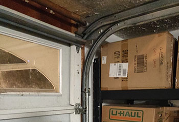 Worn garage door tracks and frayed cables being replaced in Grapevine home garage