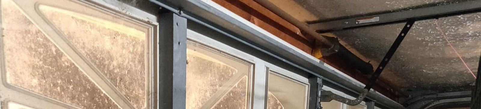 Worn garage door tracks and frayed cables being replaced in Grapevine home garage